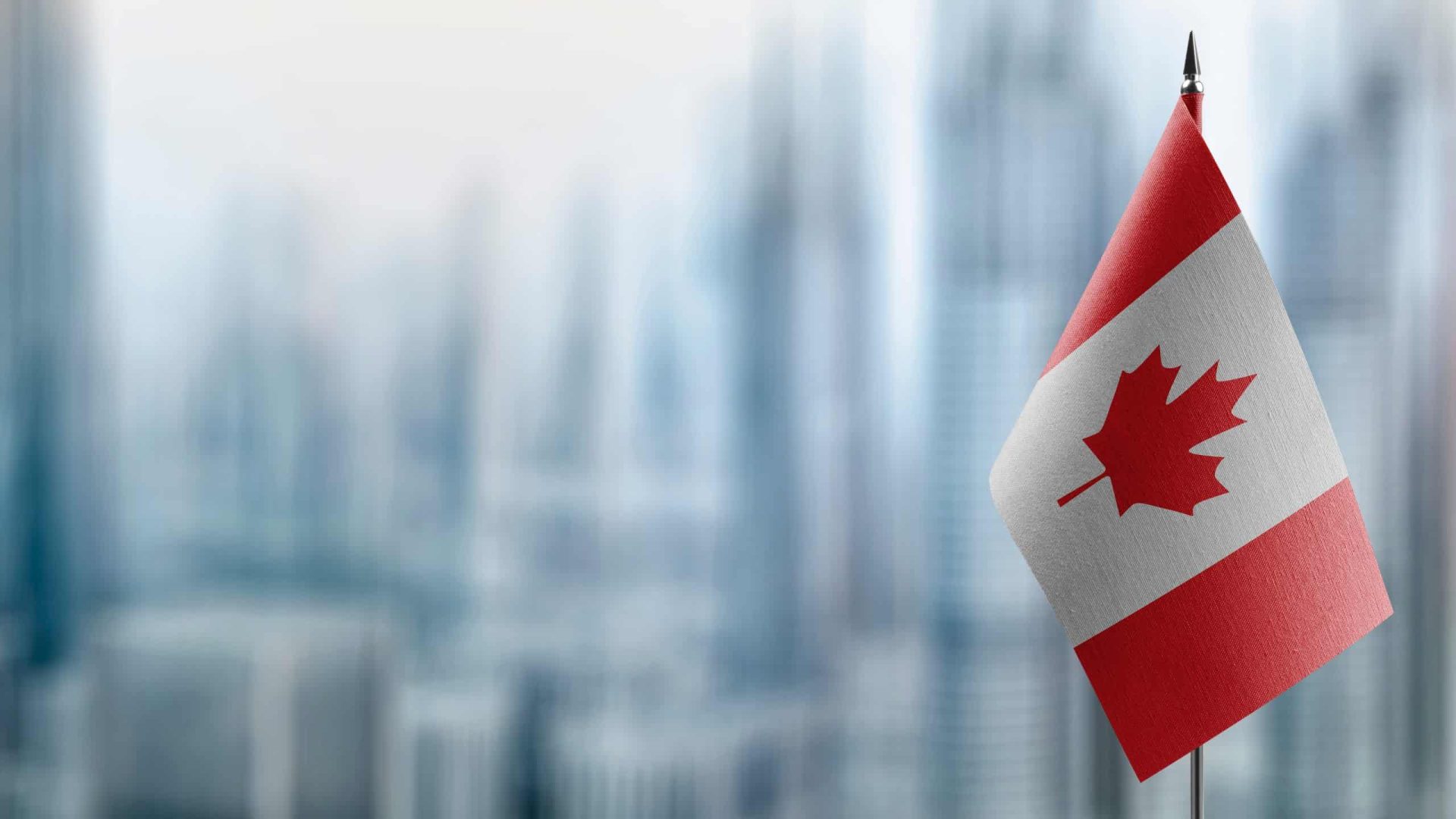 Small,Flags,Of,The,Canada,On,An,Abstract,Blurry,Background.